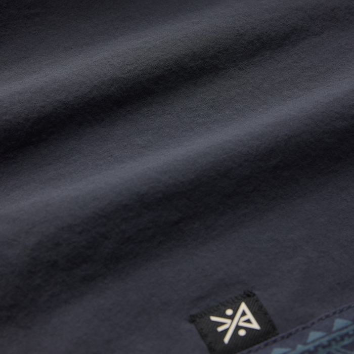Charcoal gray Passage Panel Boardshorts in Ebony with Roark brand label visible on fabric detail shot