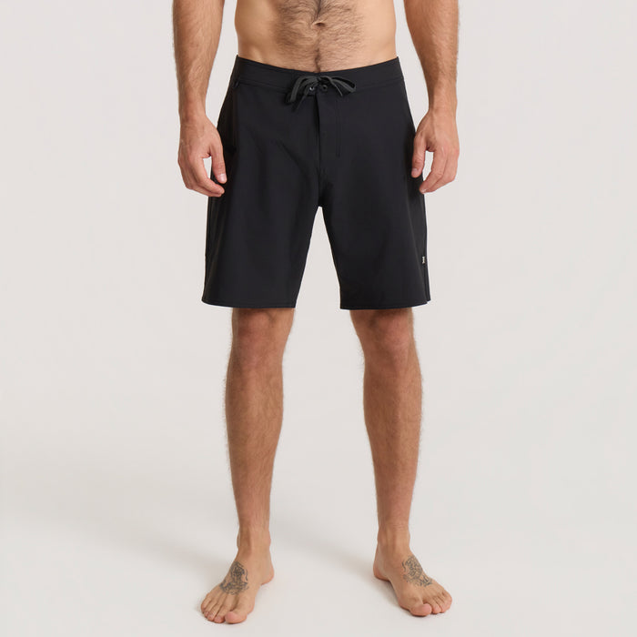 Black board shorts with drawstring waist on male model shown full-length against neutral background