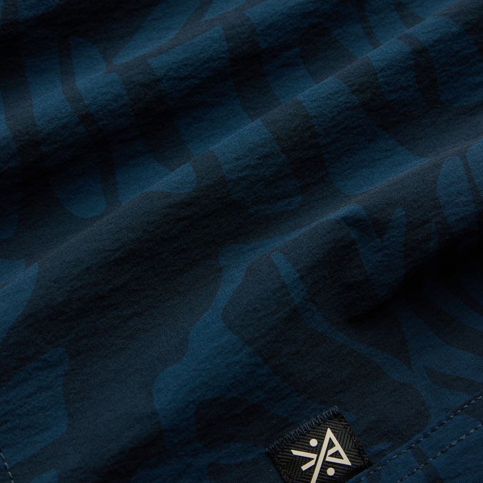 Close-up of durable navy denim fabric, embodying Roark's commitment to resilient adventure and travel wear.