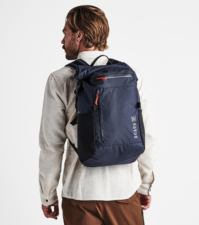 Roark Passenger 27L 2.0 Travel Bag in Blue, showcasing the bag's top handle and adjustable shoulder strap.