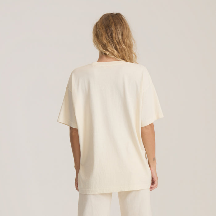 Plant Seeds Oversized Premium Tee in bone worn by model, shown from back view highlighting relaxed fit and short sleeves
