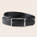 Black leather belt with a silver buckle on a beige background