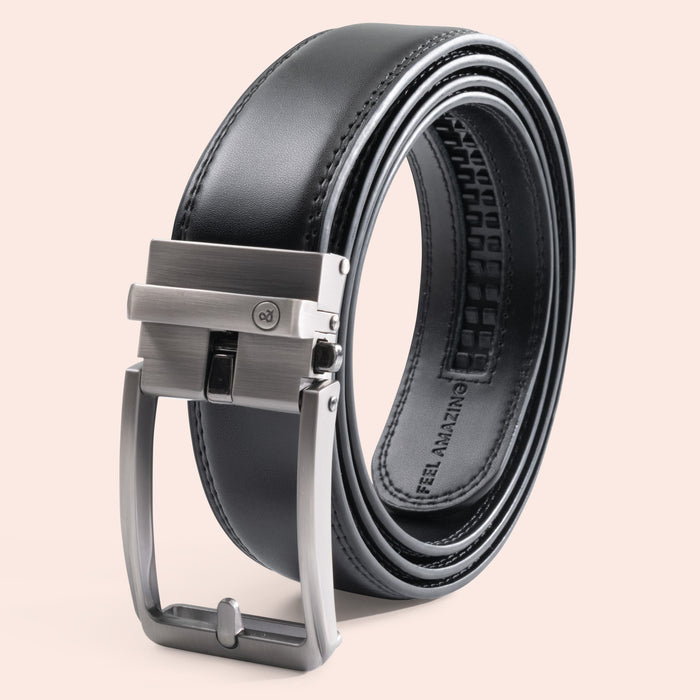 Black leather belt with silver buckle on a beige background