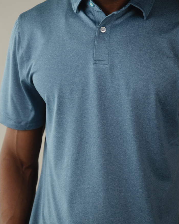 Man wearing a heather blue polo shirt
