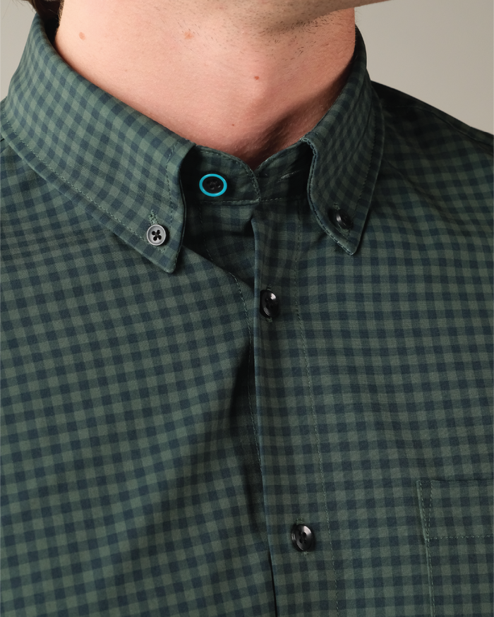 Forest green and navy gingham shirt. Black buttons. Button down collar. Top button has blue ring.