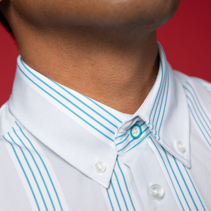 Man wearing Grey shirt with blue and white stripes. Top button has blue ring