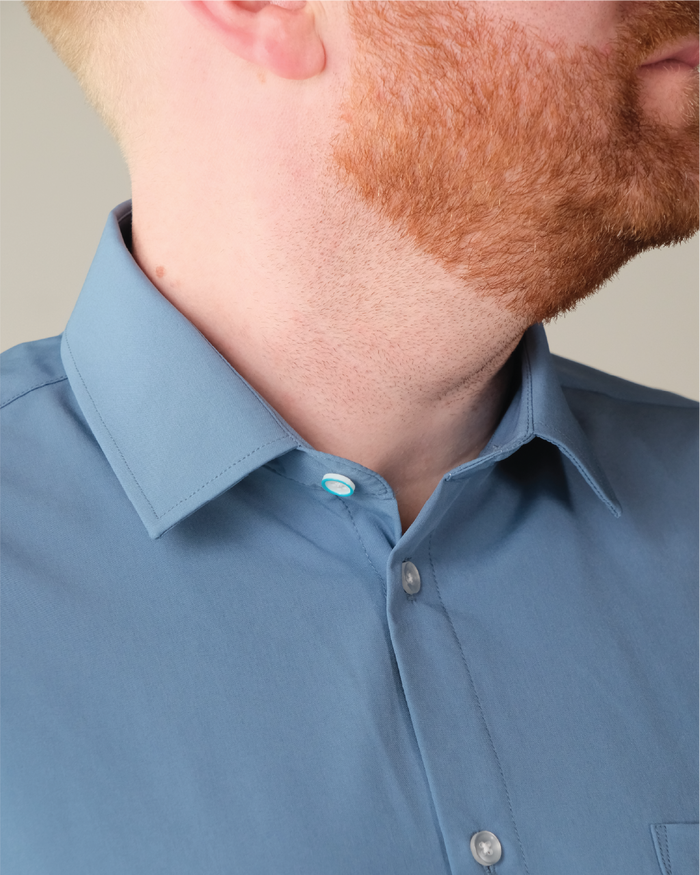 Man wearing ocean blue shirt, blue ring on top button
