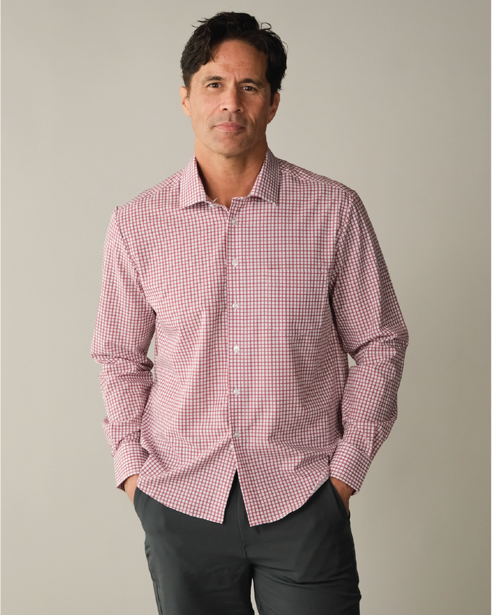 Man wearing a red and white checkered shirt with blue accent