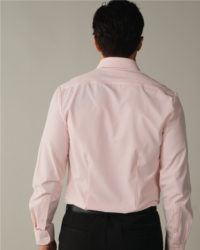 Man wearing a solid pink dress shirt