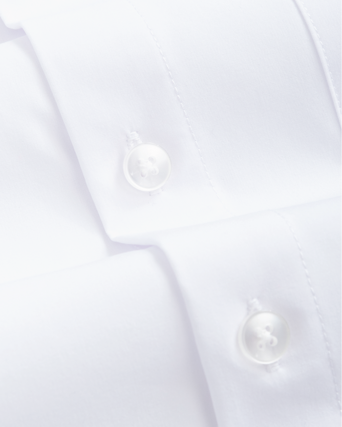 Fabric closeup of kids white dress shirt