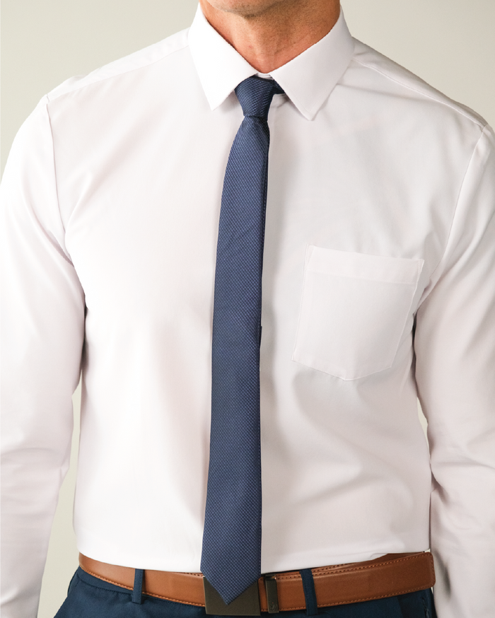 A man wearing a white dress shirt with a tie