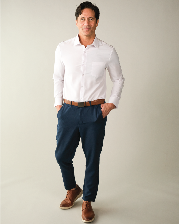 Man wearing a white dress shirt, with pocket, and brown belt