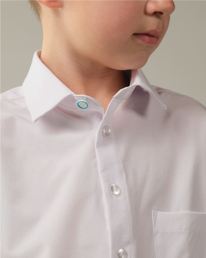 Kid white shirt. Top button has blue ring