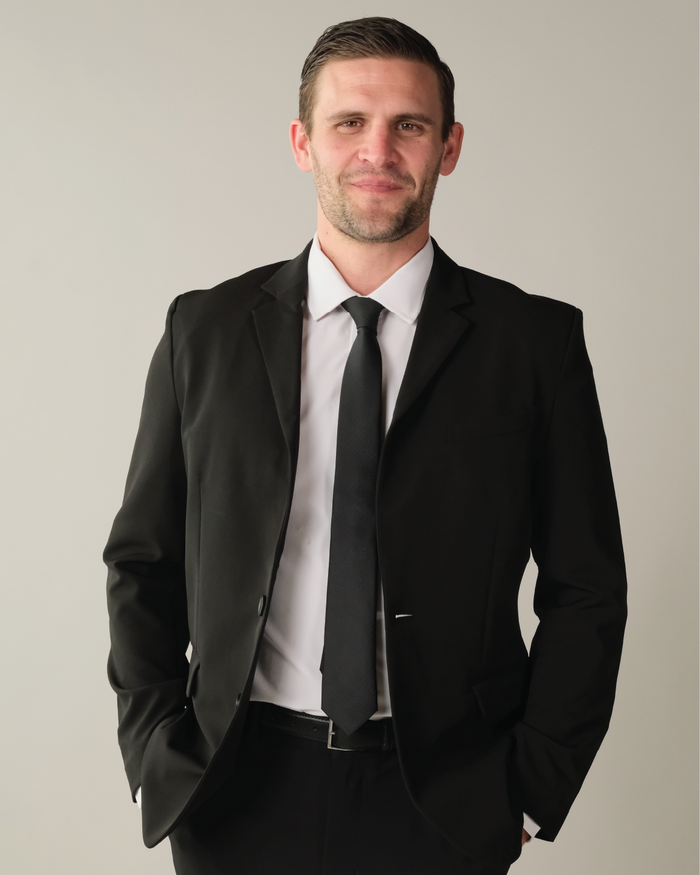 Man wearing a black suit and tie