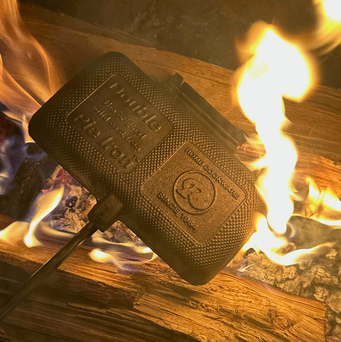Rome Double Cast Iron Pie Iron 1605 Angled Over Campfire Coals Showing Full Handle Length - Side View | United RV Parts