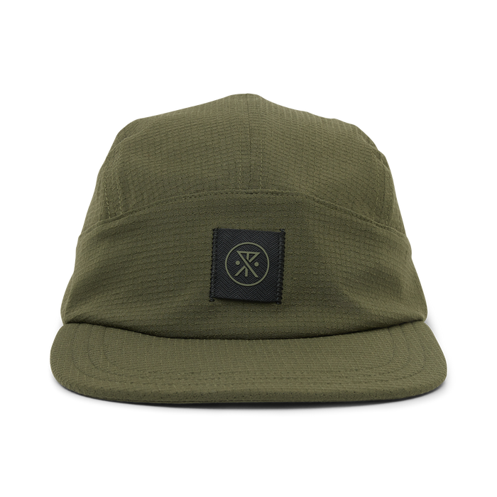 Olive green camper hat with woven texture and black branded patch on front, displayed on white background