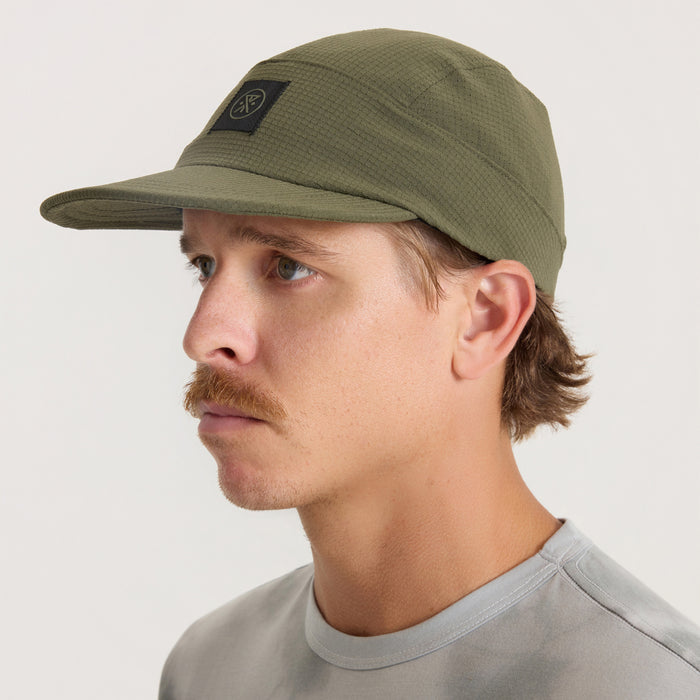 Olive green Run Bless Up Camper Strapback Hat worn by man in profile view showing structured crown and extended brim