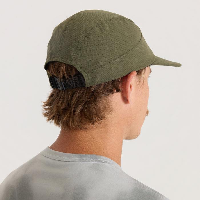 Olive green camper hat with extended visor and black adjustable strapback closure, worn by model in side profile view