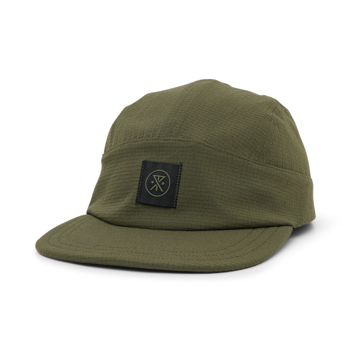 Olive green camper hat with black woven logo patch on front, displayed on white background in three-quarter view