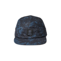 Run Amok five-panel cap in a blue and black splatter pattern, featuring a structured front panel with a woven patch logo. Perfect for outdoor adventures and urban style.