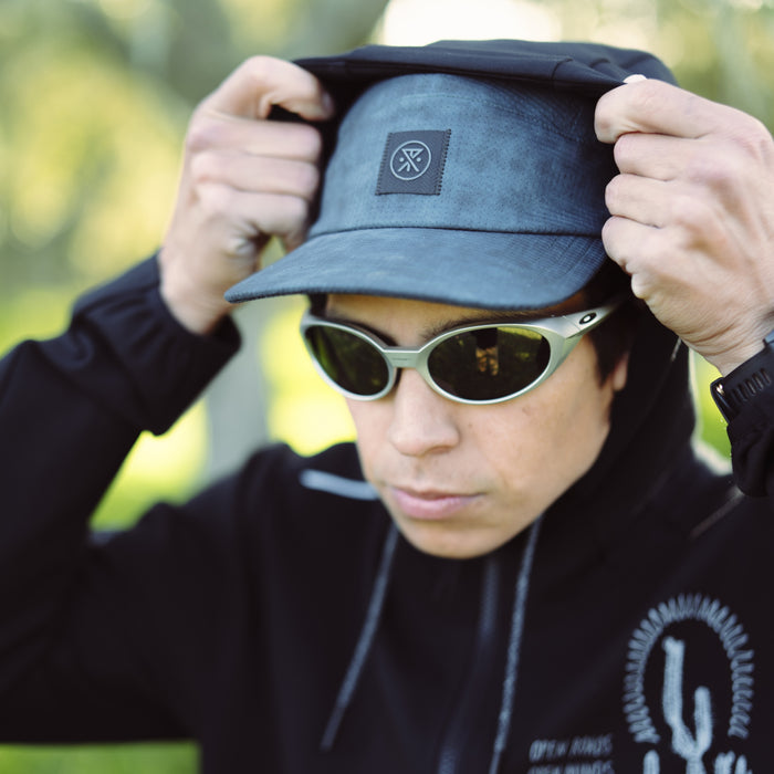 Roark Run Bless Up Camper Strapback Hat displayed outdoors, showcasing its versatile design perfect for adventurers and travelers.