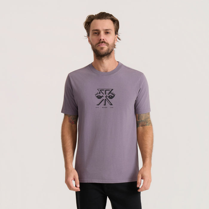 Mauve purple short sleeve t-shirt with black graphic eye design on male model wearing black pants