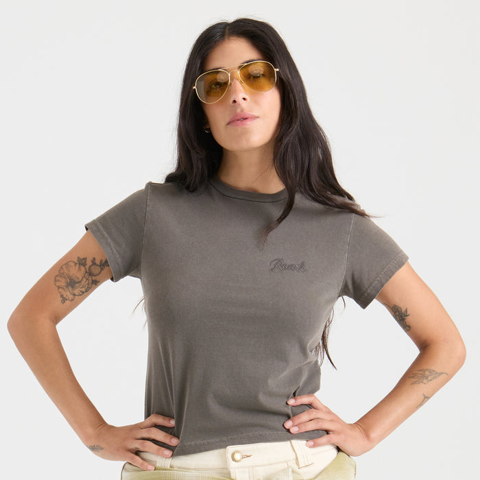 Outdoor adventure-inspired clothing featuring a visible brown shirt with detailed stitching on the sleeve and shoulder, perfect for travel and exploration.