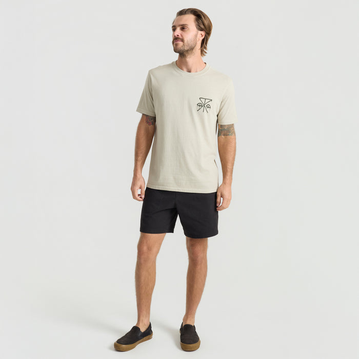 Man exploring outdoors wearing Roark boardshorts and active shirt, perfect for adventure and travel.