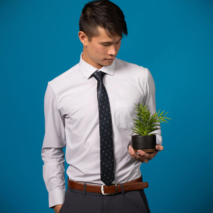 Navy blue tie with green cactus pattern on a white shirt