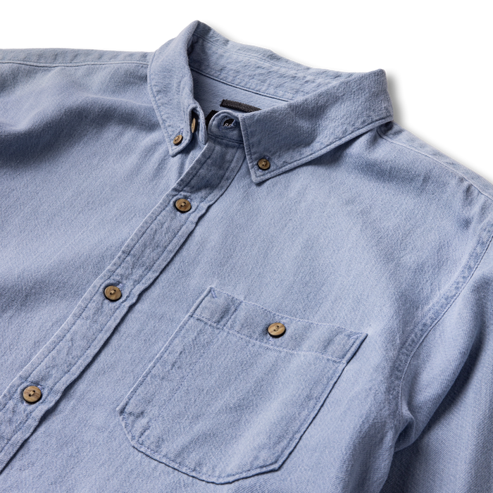 Close-up view of a durable button on outdoor adventure gear by Roark