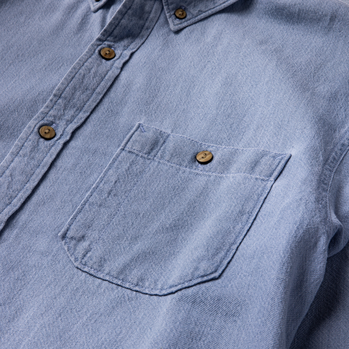 Close-up of a rugged button on outdoor apparel, embodying Roark's commitment to durable travel gear