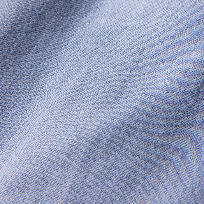 Close-up of a textured blue denim and linen woven fabric, evoking a rugged, adventure-ready feel for outdoor explorations.