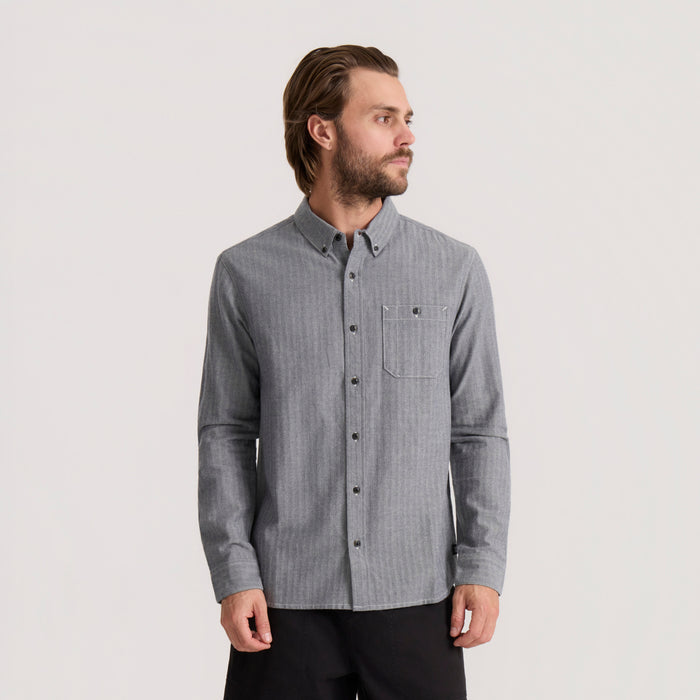 Gray chambray button-up shirt with chest pocket worn by man against neutral background, full front view
