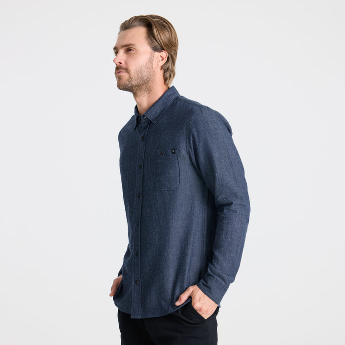 Close-up of a durable button detail on outdoor apparel by Roark, embodying rugged adventure and travel readiness.