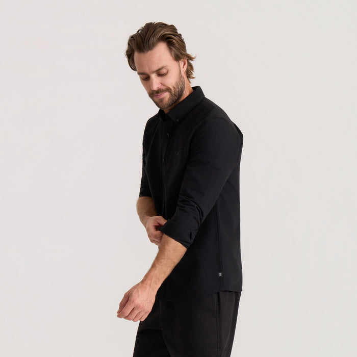 Black Scholar Chambray Button Up Shirt worn by man in side profile view on neutral background