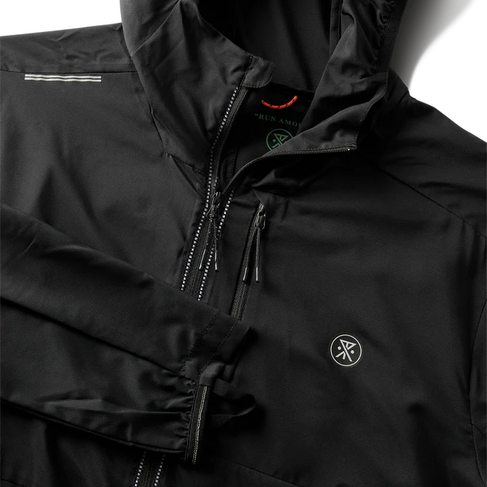Stylish leather and windbreaker jackets perfect for adventure and travel, displayed in an outdoor setting, embodying Roark's rugged aesthetic.