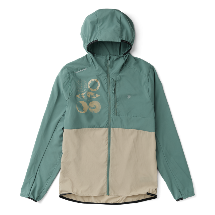 Model wearing a Roark hooded windbreaker, designed for adventure and outdoor exploration, in a natural setting.