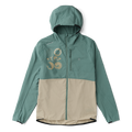 Model wearing a Roark hooded windbreaker, designed for adventure and outdoor exploration, in a natural setting.