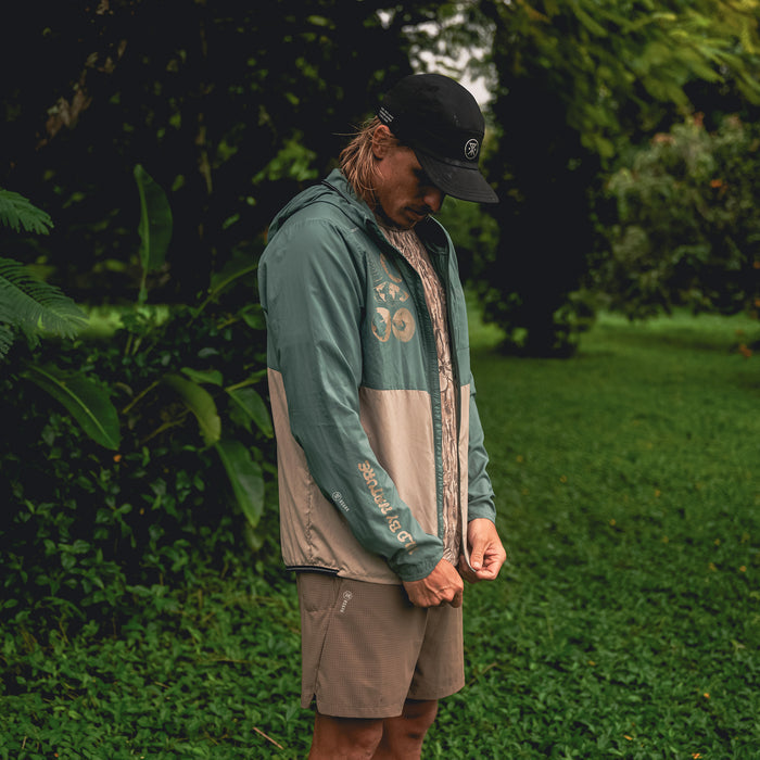 Roark Secondwind 3.0 Jacket featuring a lightweight windbreaker design with a hood, perfect for adventure and travel.