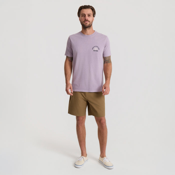 Model showcasing a versatile range of Roark boardshorts and active wear in a dynamic outdoor setting, ideal for adventure and travel.