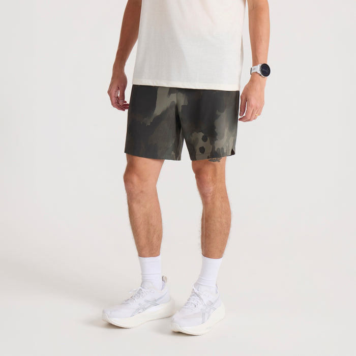 Serrano 7" Active Stretch Shorts in camo print worn by man with white t-shirt and white sneakers, front view on model