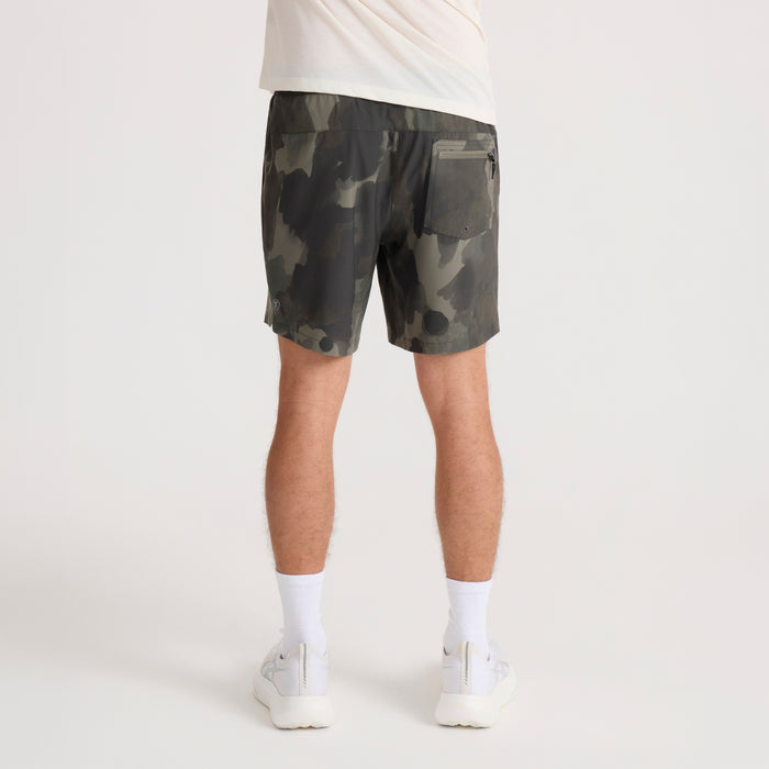 Serrano camo shorts with green and tan camouflage pattern, back pocket detail, worn with white tee and socks on model