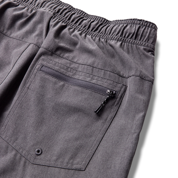 Close-up of grey active denim pants highlighting detailed pocket design and waist area, perfect for adventure and travel.