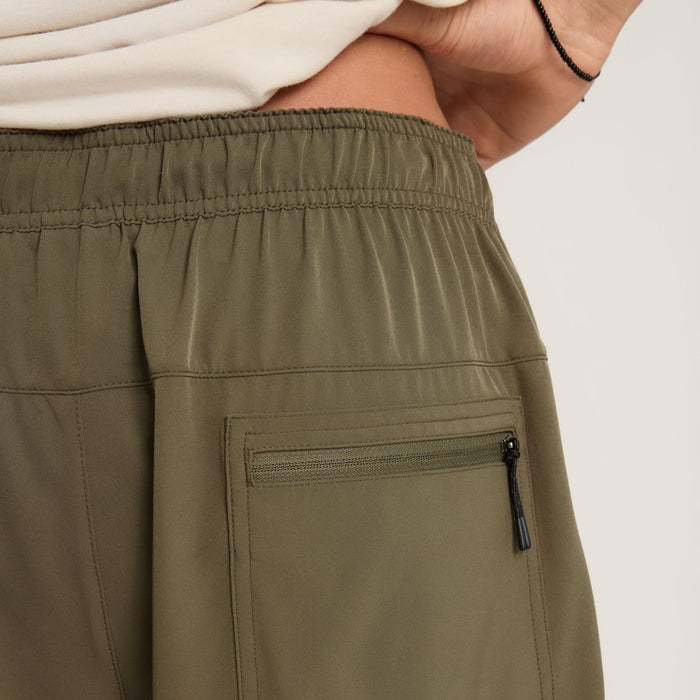 Active pants designed for adventure and outdoor activities by Roark, showcasing durability and comfort in a natural setting.