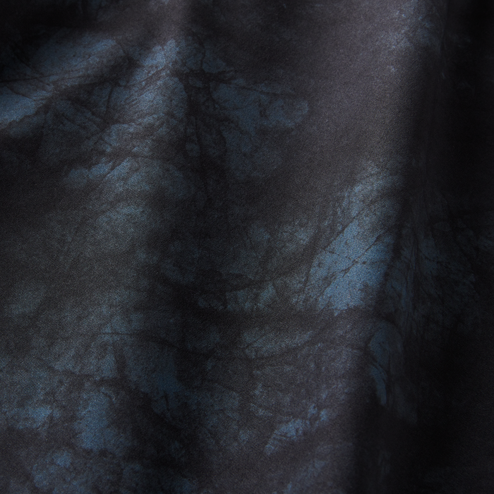 Detailed view of the navy tie-dye fabric showcasing intricate blue patterns, adding a unique touch to the summer wardrobe.