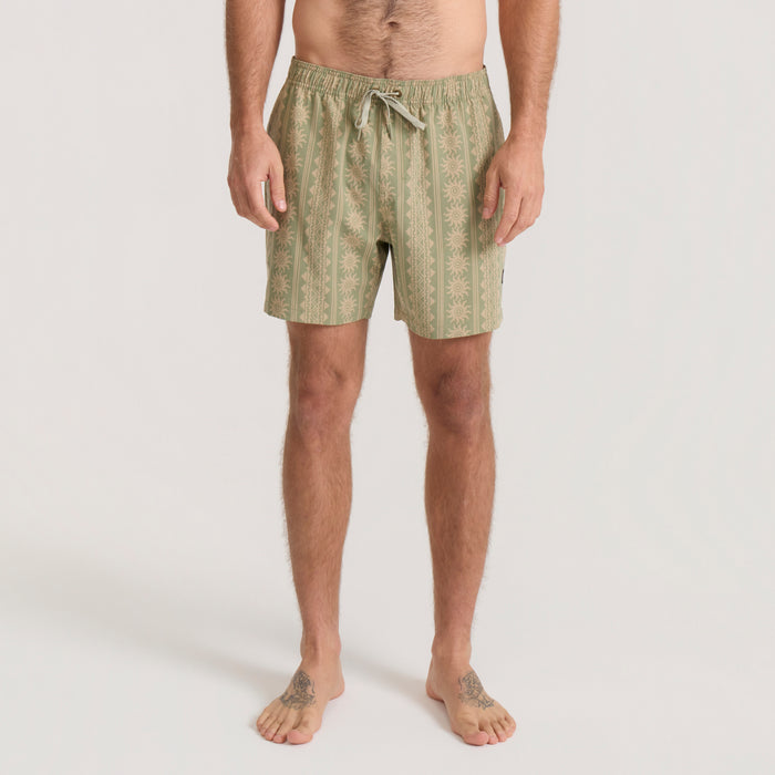 Dusty sage patterned Shorey swim trunks with drawstring waistband on male model, front view