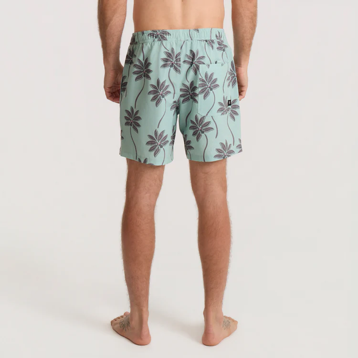 Shorey 16" Trunks in hazy blue with dark palm tree print, worn by male model shown from back view
