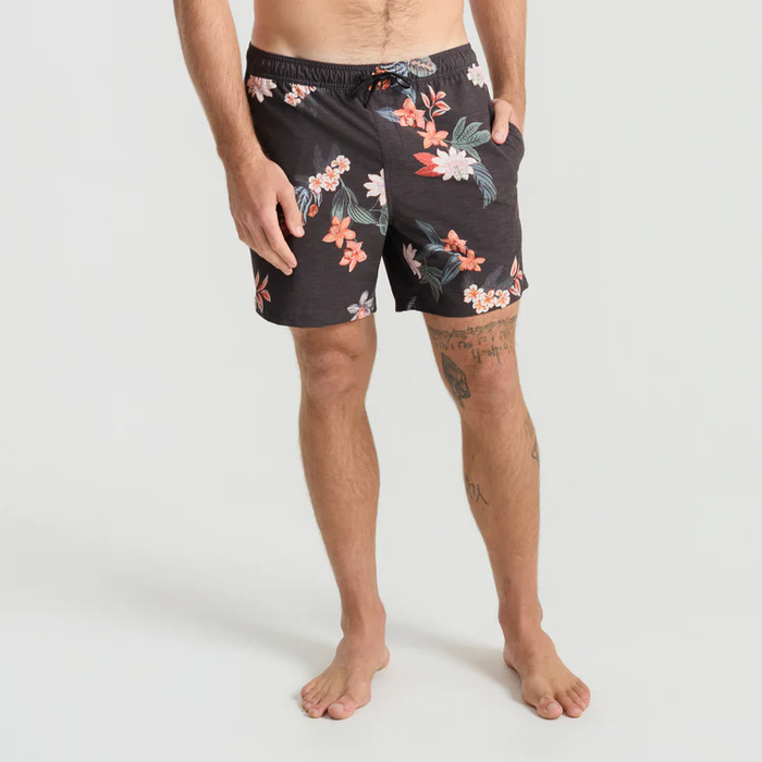 Shorey 16" Trunks in onyx with coral and white floral print, worn by man standing against neutral background