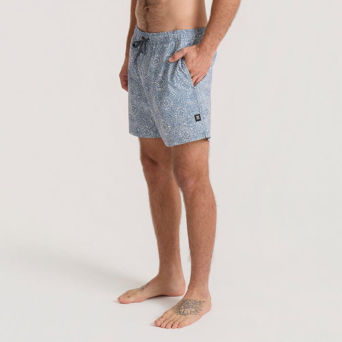Slate blue Shorey boardshorts with all-over geometric print, drawstring waist, side pockets, worn on model against neutral background