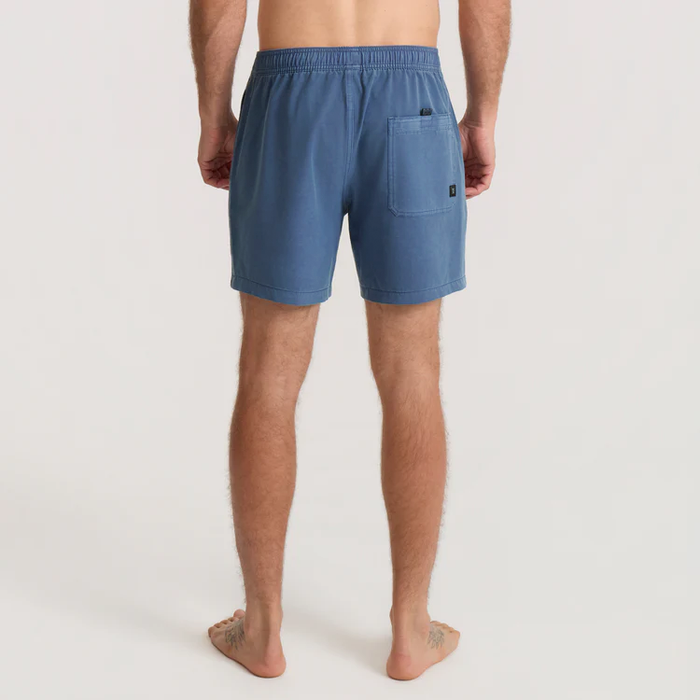 Shorey 16" Trunks in washed indigo, worn by male model shown from behind, displaying rear pocket and elastic waistband detail